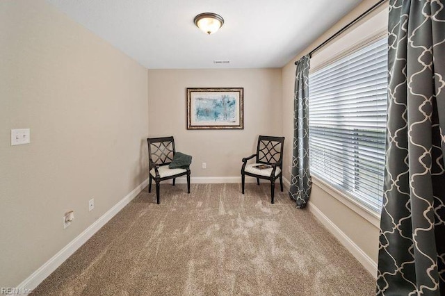 living area featuring a healthy amount of sunlight and carpet floors