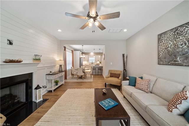 living room featuring ceiling fan and hardwood / wood-style floors