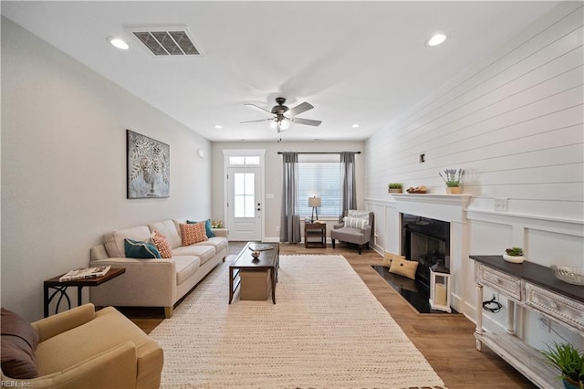 living room featuring hardwood / wood-style floors and ceiling fan