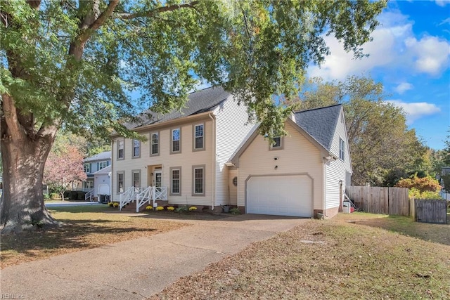 colonial-style house with a garage and a front yard