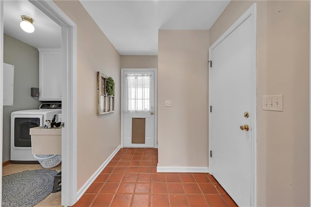 hall featuring light tile patterned floors and washer and clothes dryer