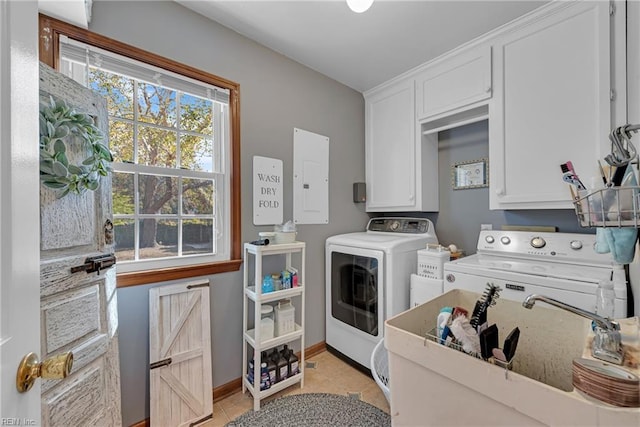 washroom with electric panel, light tile patterned floors, separate washer and dryer, and cabinets