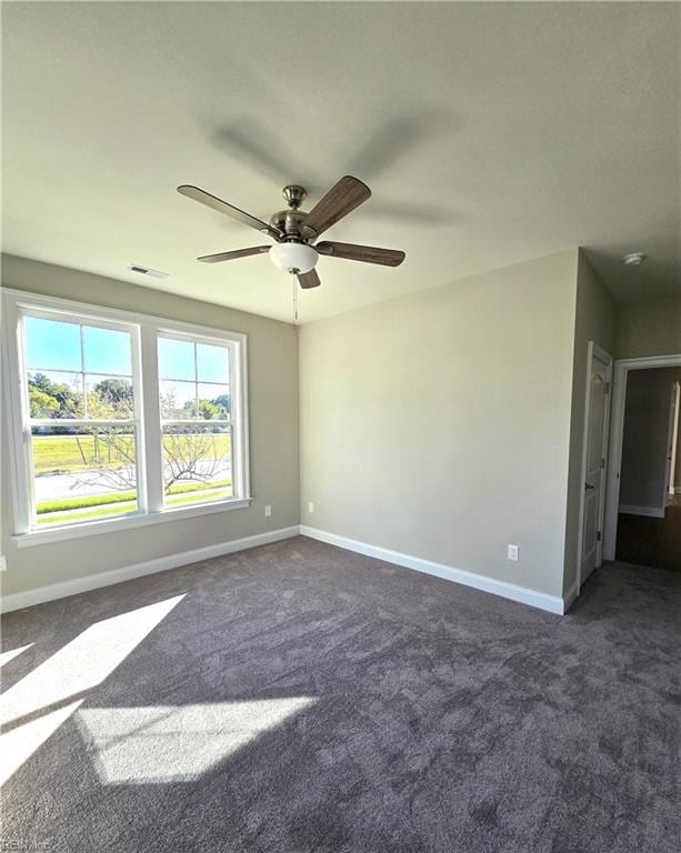 carpeted spare room with ceiling fan