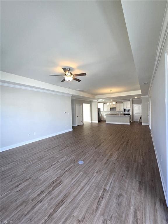 unfurnished living room featuring ceiling fan and dark hardwood / wood-style flooring