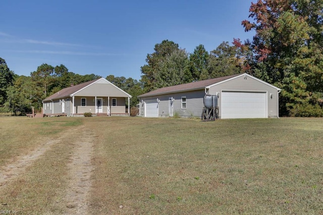 view of front of property featuring a front yard, an outdoor structure, and a garage