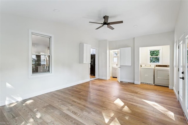 unfurnished bedroom featuring light hardwood / wood-style flooring, ensuite bathroom, washer and clothes dryer, and ceiling fan