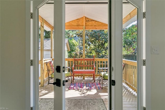 doorway featuring french doors and lofted ceiling