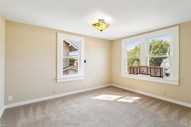 empty room with carpet flooring and plenty of natural light