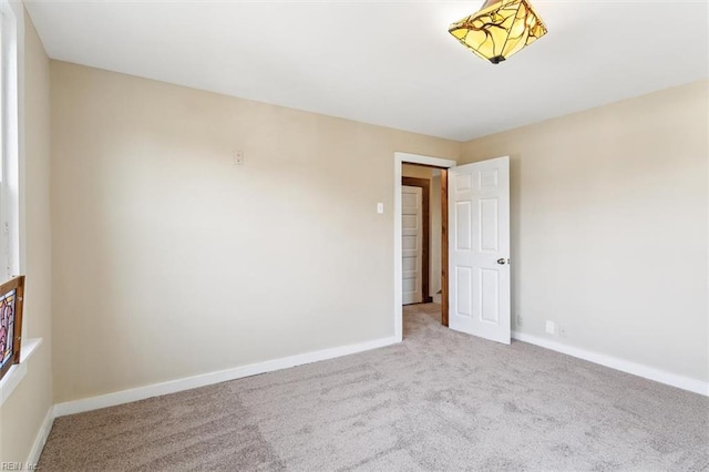 unfurnished room featuring light colored carpet