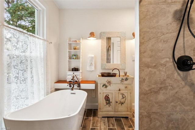 bathroom featuring vanity, hardwood / wood-style flooring, and a bathtub