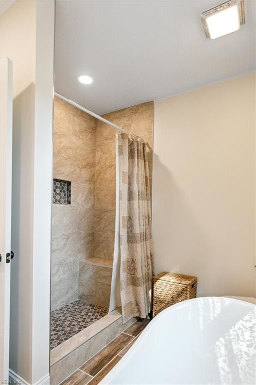 bathroom featuring plus walk in shower