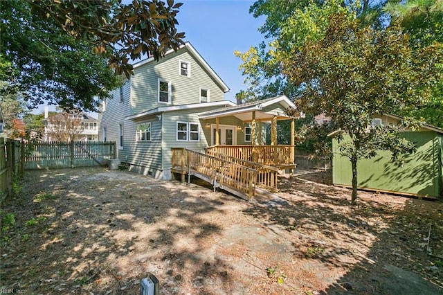 back of property featuring a wooden deck