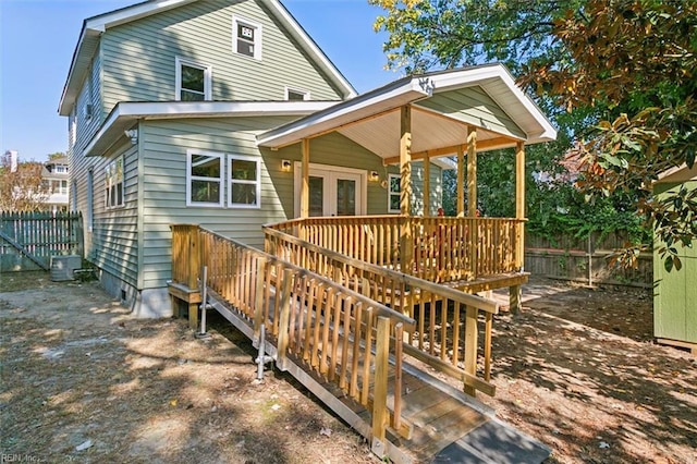 rear view of property with a wooden deck