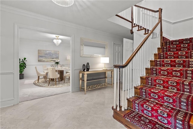 staircase featuring carpet flooring, a chandelier, and ornamental molding