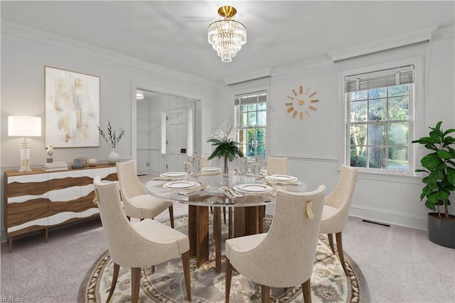 carpeted dining space with a chandelier, crown molding, and a healthy amount of sunlight