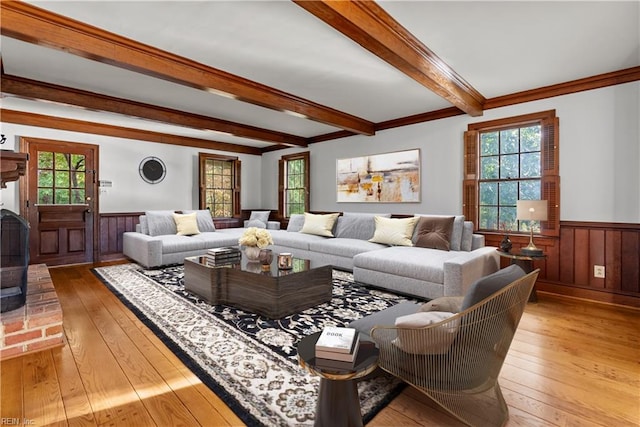 living room with beamed ceiling, ornamental molding, and hardwood / wood-style flooring