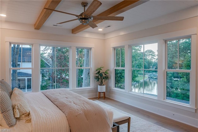 bedroom with multiple windows and hardwood / wood-style flooring