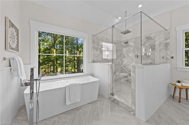 bathroom featuring separate shower and tub