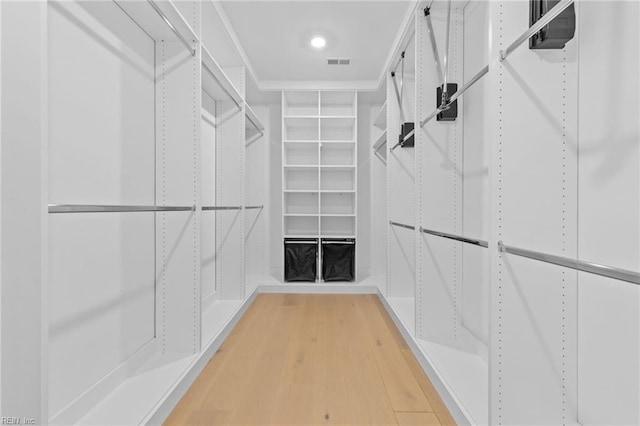 spacious closet with hardwood / wood-style flooring