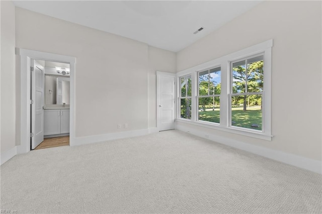 unfurnished room featuring light colored carpet