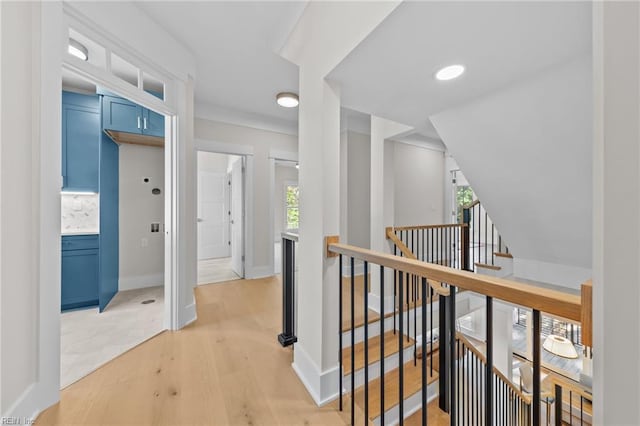 hall with a wealth of natural light and light wood-type flooring