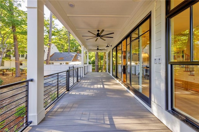 wooden deck featuring ceiling fan