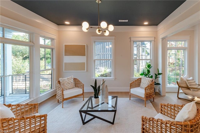 sunroom with a chandelier and a healthy amount of sunlight