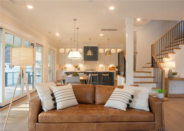 living room with sink and light hardwood / wood-style flooring