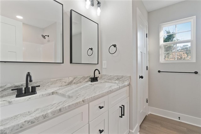 bathroom with vanity, a shower, and hardwood / wood-style floors