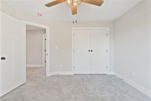 unfurnished bedroom featuring a closet, ceiling fan, and light colored carpet