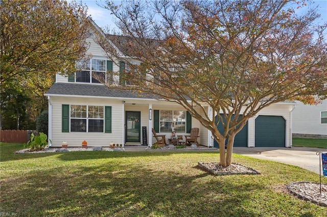 view of front of home with a front yard and a garage