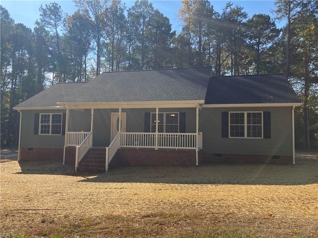 ranch-style house featuring crawl space, covered porch, and roof with shingles