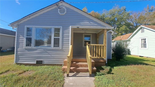 bungalow-style house with a front yard and a porch