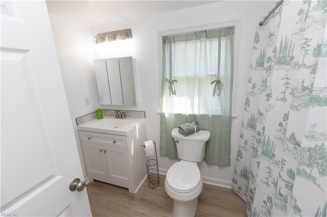 bathroom featuring vanity, toilet, wood-type flooring, and curtained shower