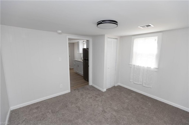 empty room featuring light colored carpet