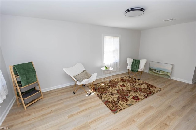 living area with light hardwood / wood-style flooring