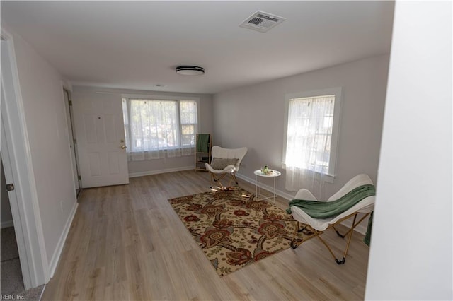 sitting room featuring light hardwood / wood-style flooring