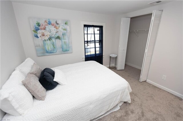 bedroom with a closet and light colored carpet