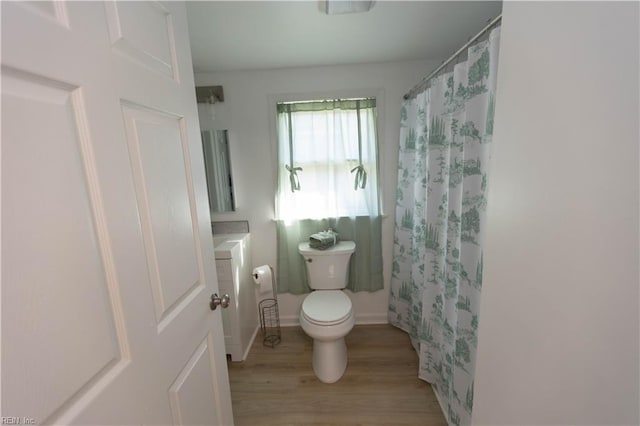 bathroom with toilet, a shower with curtain, vanity, and wood-type flooring