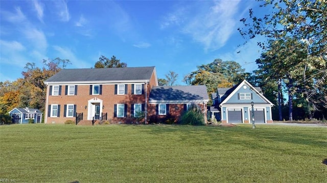 colonial-style house with a front yard and a garage