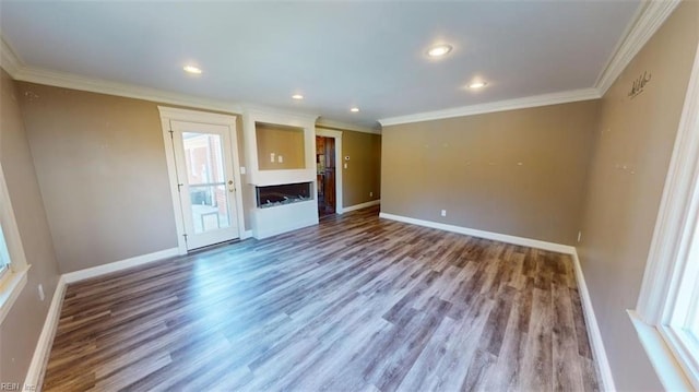 unfurnished living room featuring crown molding and hardwood / wood-style floors