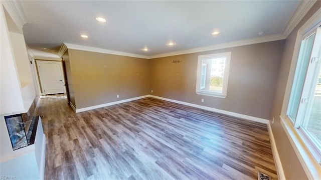 spare room with crown molding and wood-type flooring