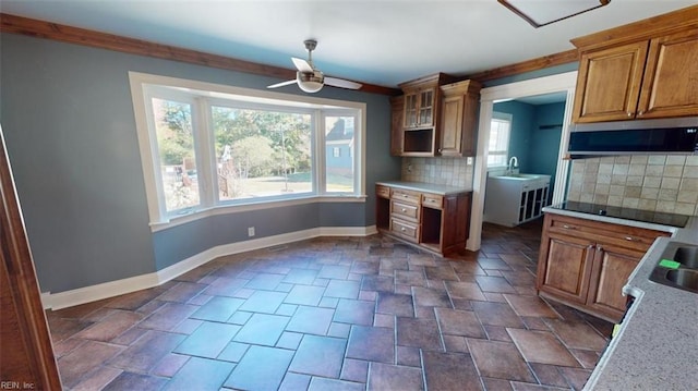 kitchen with ceiling fan, a wealth of natural light, ventilation hood, and backsplash