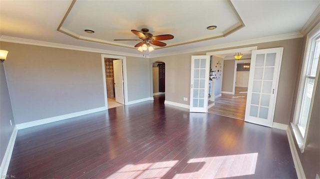 empty room with ornamental molding, french doors, dark hardwood / wood-style floors, and a tray ceiling