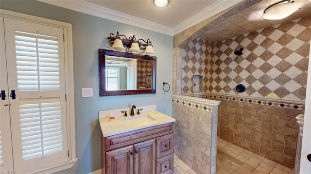 bathroom with vanity, crown molding, tile patterned floors, and a shower