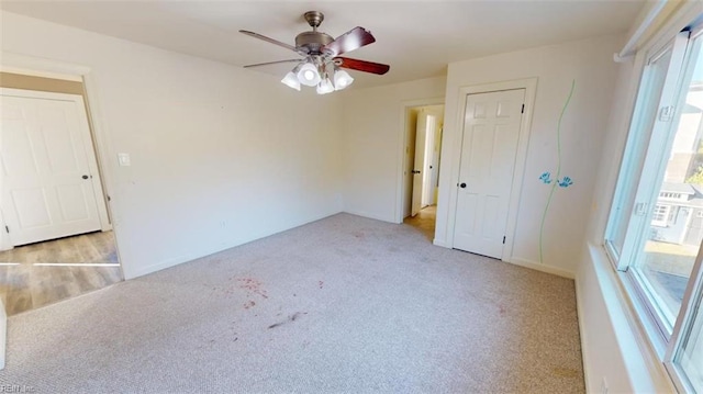 empty room with light carpet and ceiling fan