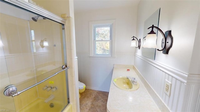 full bathroom with vanity, toilet, tile patterned floors, and combined bath / shower with glass door