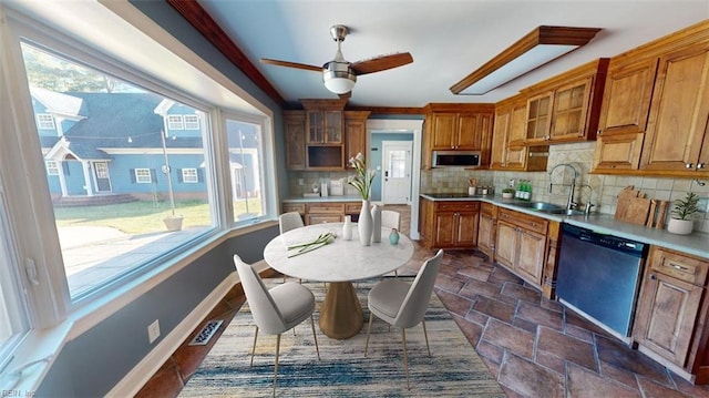 kitchen with a healthy amount of sunlight, ceiling fan, stainless steel appliances, and decorative backsplash