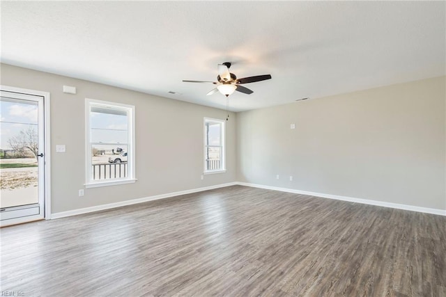 unfurnished room with dark wood-type flooring and ceiling fan