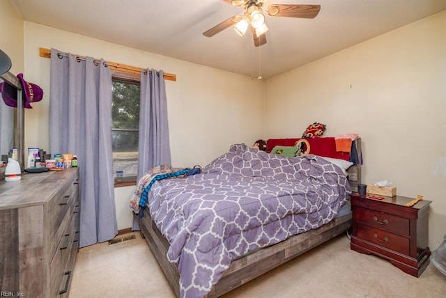 bedroom featuring light colored carpet and ceiling fan